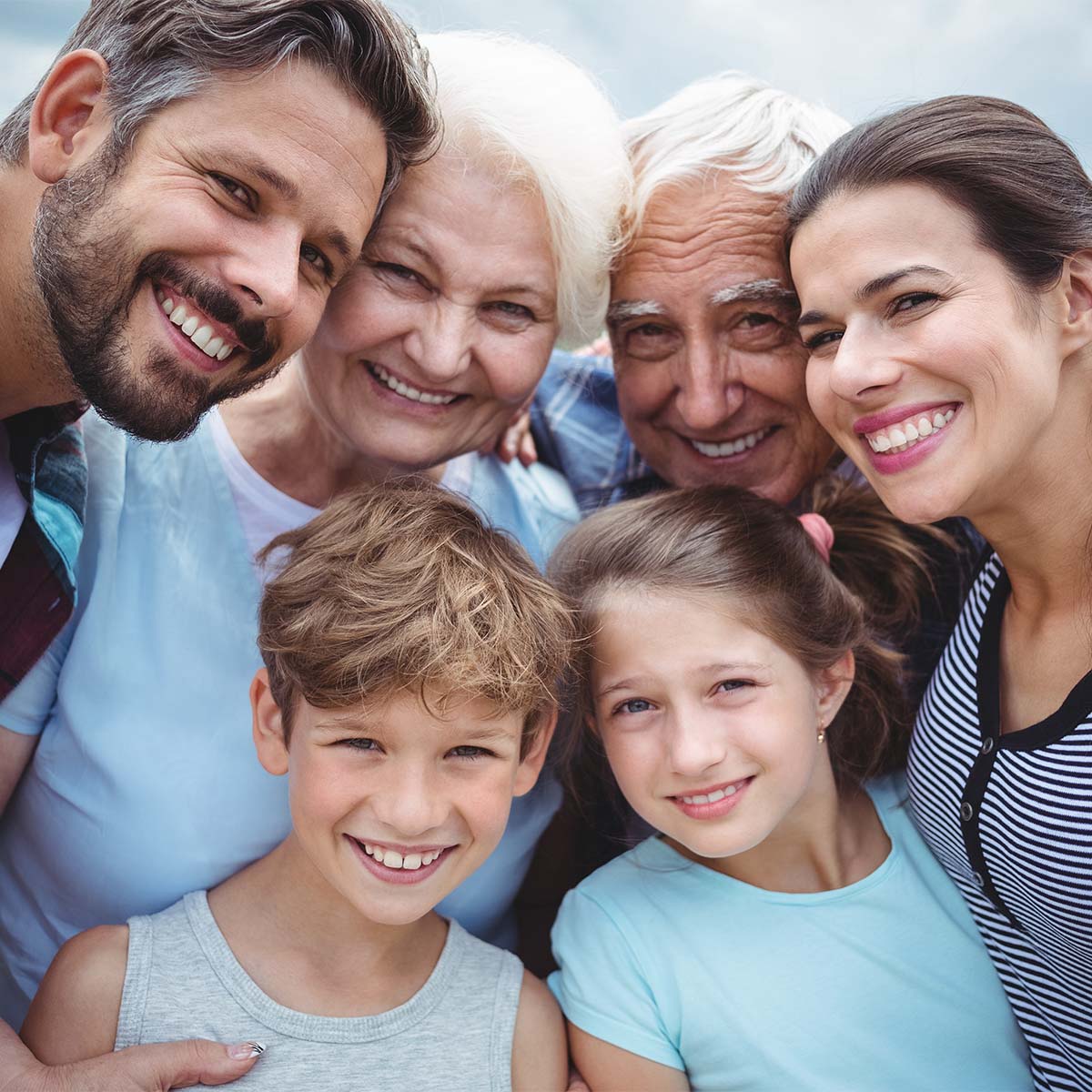 smiling family with kids and grandparents